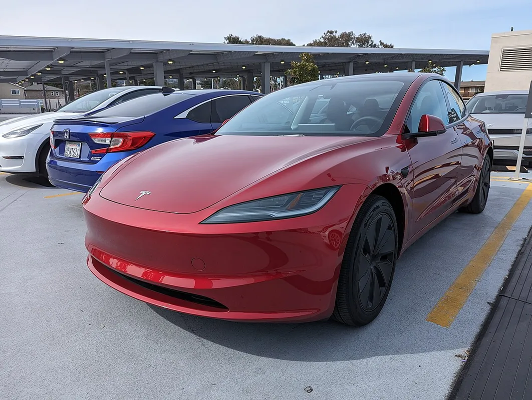 A Tesla Model 3 Highland seen from the front three-quarter angle